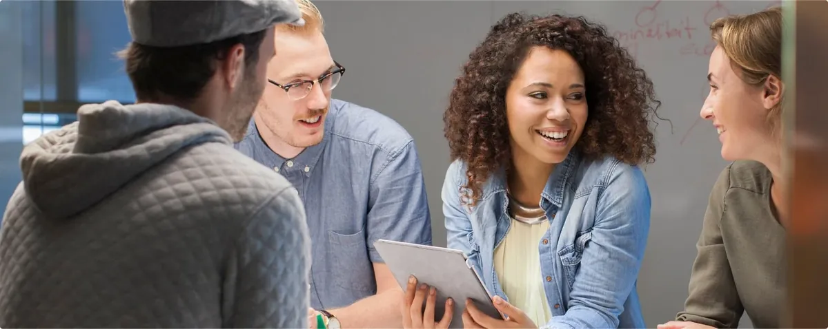 Colleagues smiling while working through a plan together