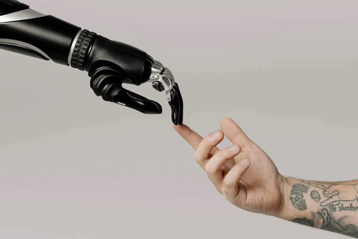 A human hand and a robotic hand reaching toward each other