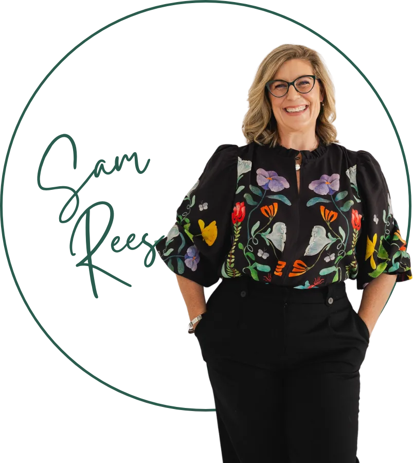 Sam Rees, founder of Orby, smiling in a floral blouse, framed by her signature